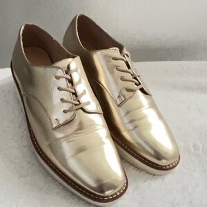 Ladies metallic gold tie up leather wedge oxfords by ALDO.